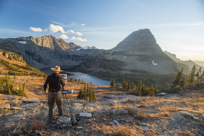 Artist Dennis Farris painting in Glacier National Park